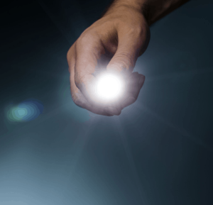 A man holding a blindingly white flashlight