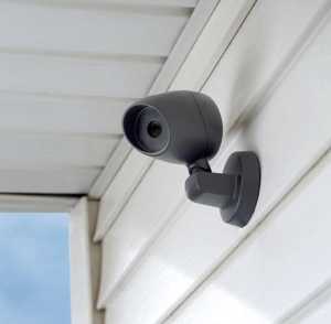 A dummy camera set up at the side of a house