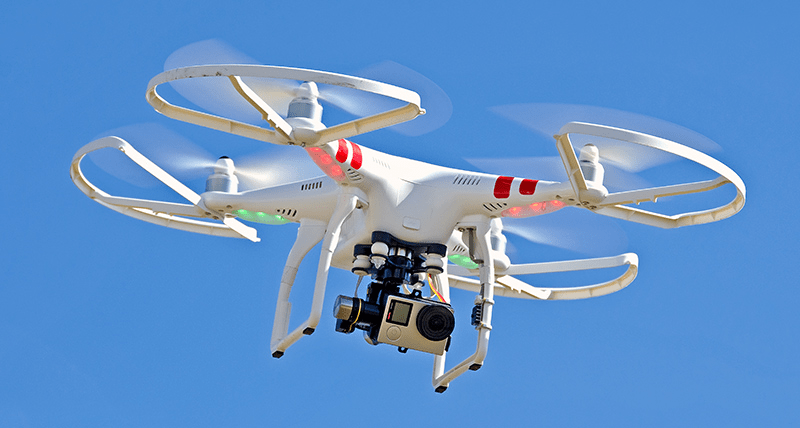 A quadcopter armed with a camera flying on the sky