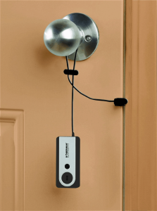 A portable alarm hanging from the doorknob