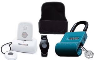 Medical alert button with key lock and cradle charger